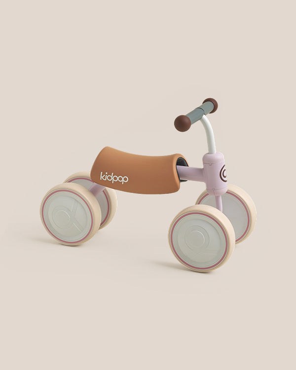 BIG BEE Baby Balance Bike, pastel pink with tan seat, cream wheels, 'kidpop' logo on seat, for toddlers.