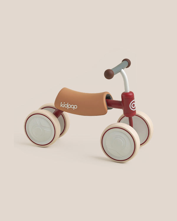 BIG BEE Baby Balance Bike, deep red four-wheel ride-on with tan seat, cream wheels, gray handlebar.