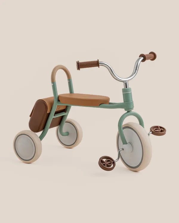 MATE Kids' aesthetic pastel green tricycle with brown seat, handlebars, saddle bag, and cream wheels.