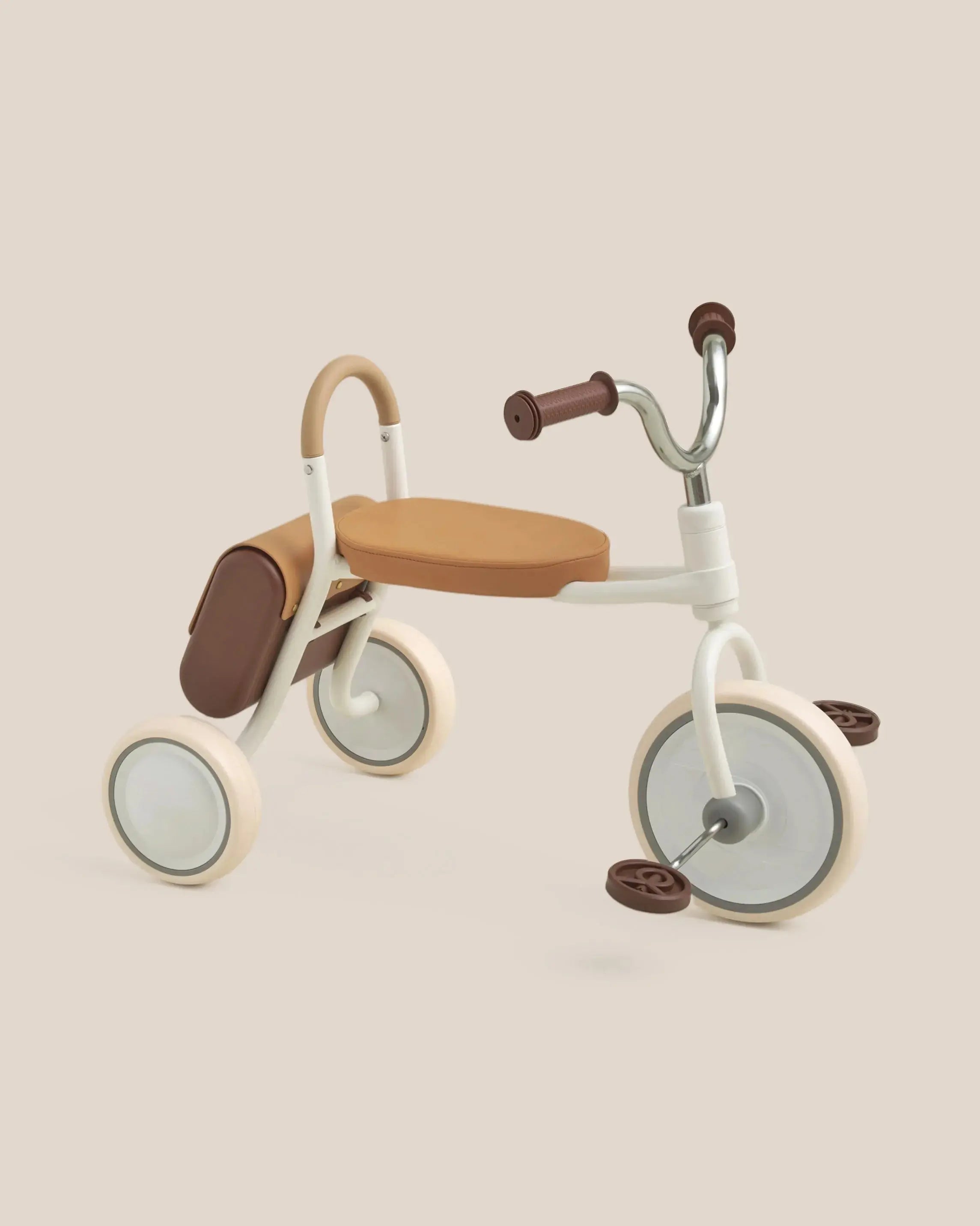 MATE Kids' cream tricycle with tan seat, brown handlebars, saddle bag, and cream wheels with tan accents. Product appearance.