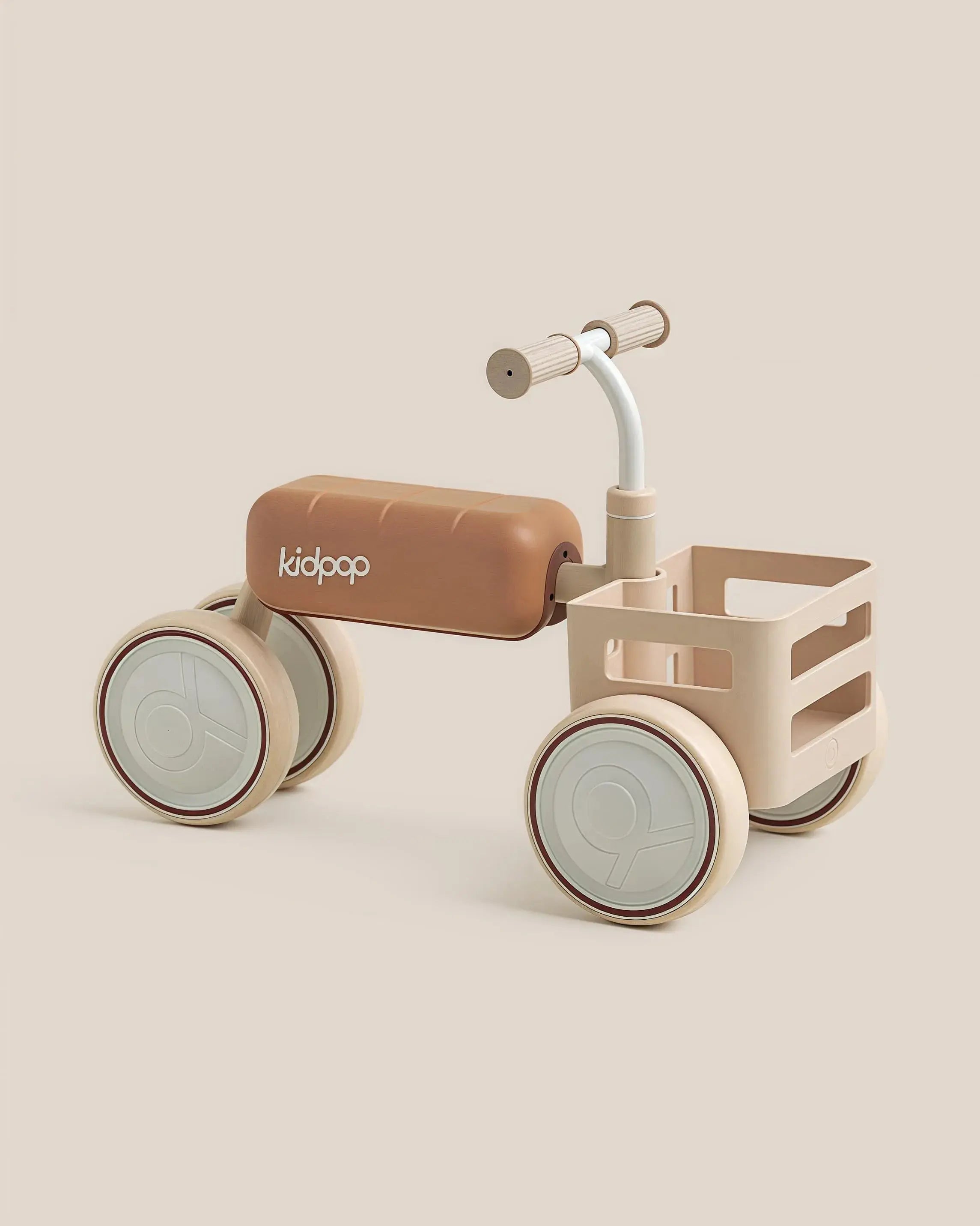 Beige TOAST Baby Balance Bike with storage basket and light-colored wheels, showcasing product appearance.
