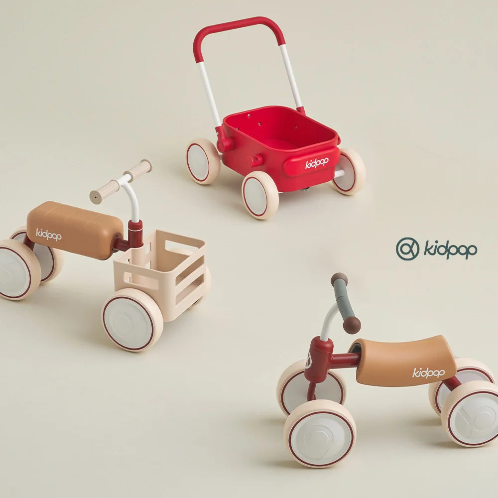 Three Kidpop ride-on toys and wagons in red and beige. 