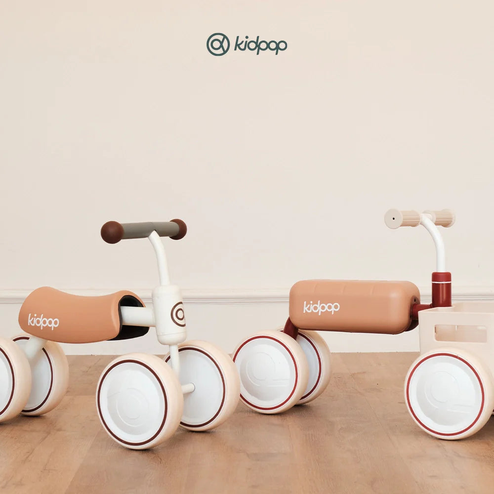 Minimalist Kidpop toddler ride-on toys in beige and red.
